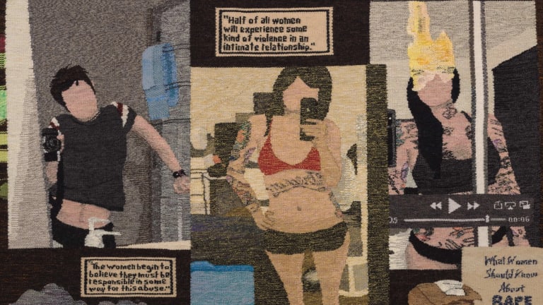 Artwork by Erin M. Riley. The work is a tapestry that depicts different figures without facial features along with text and objects across the piece.