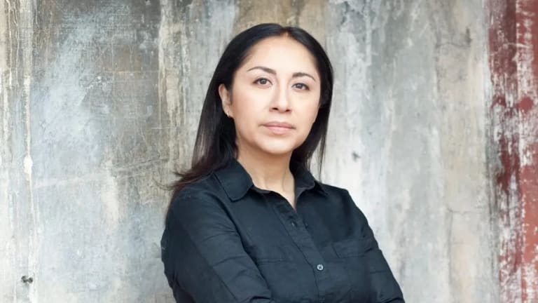 Picture of Minerva Cuevas standing against cement wall