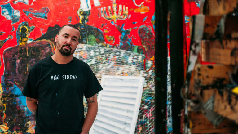 Image of Angel Otero in front of large red artwork 