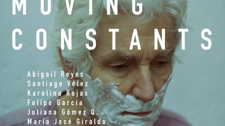 Exhibition poster featuring image of an elderly man with white hair and shaving cream on his face 