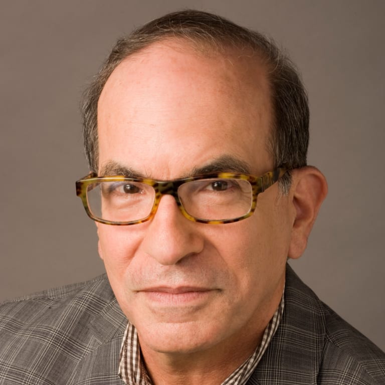 Close-up portrait of Leonard Marcus against a grey background