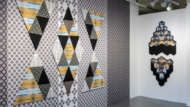 Installation of patterned work on paper in gallery