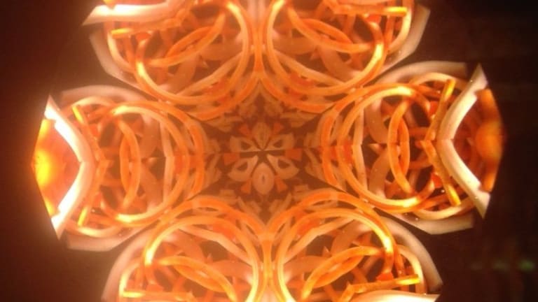 the inside of a kaleidoscope - an orange symmetrical pattern