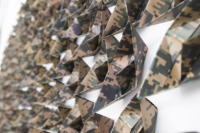 Lester Rodríguez, Hide Tide, 2014. Paper boats, camouflage, and offset printing.