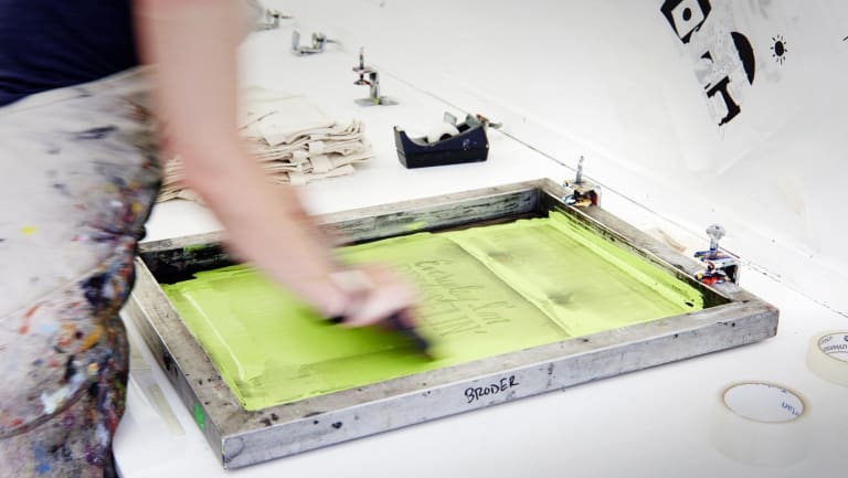 A photograph of a person making prints