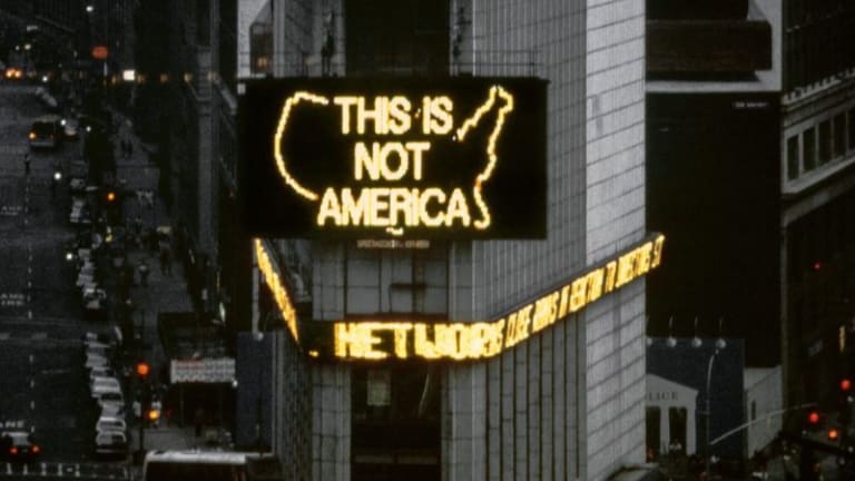 Times Square billboard reading "This is Not America"