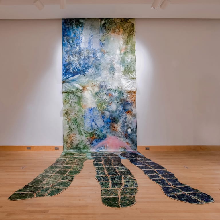 Colorful installation that cascades down to the floor made of acrylic and mixed media.