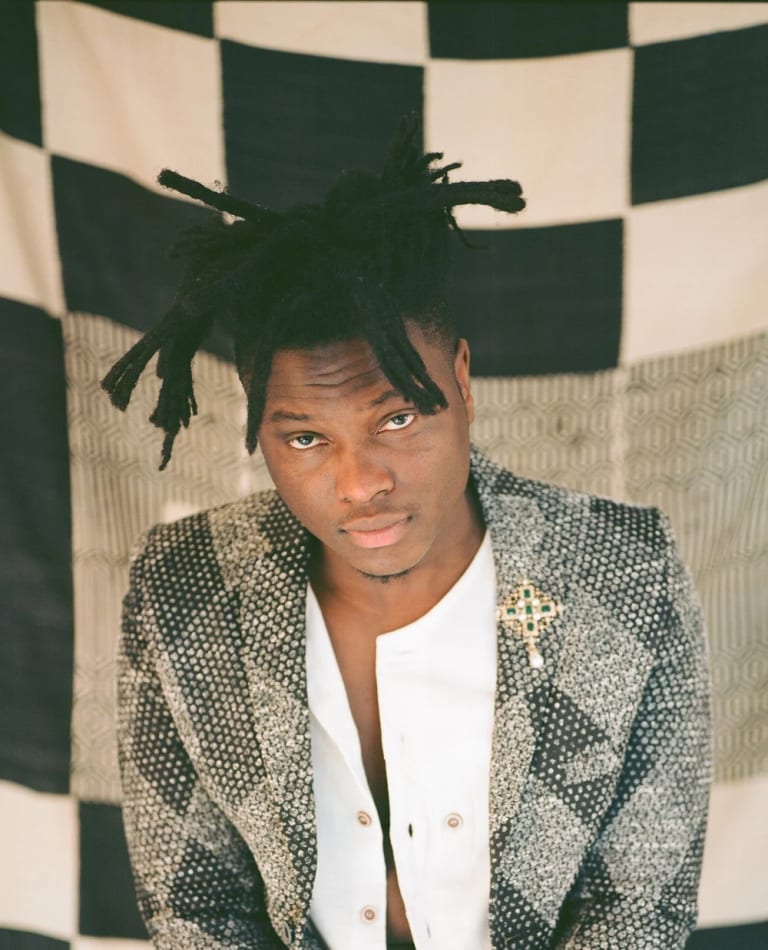 Image of Julianknxx in front of black and white textile