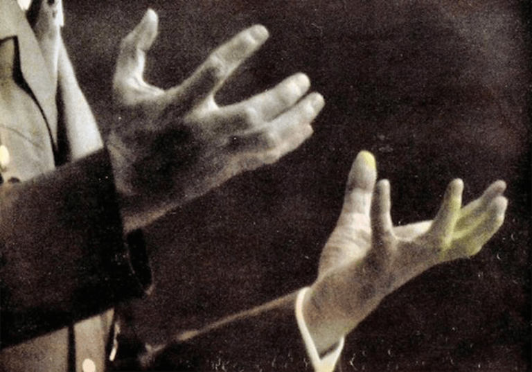 a man's hands grasping for something