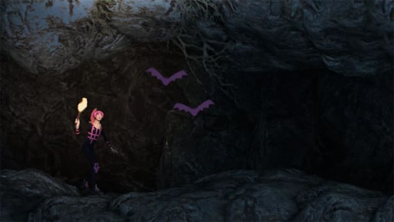 A woman holding a torch is walking through a cave; two purple bats are flything through the middle of the cave.