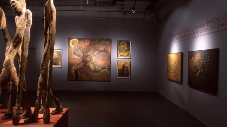 A gallery displays a series of sculptures and paintings.