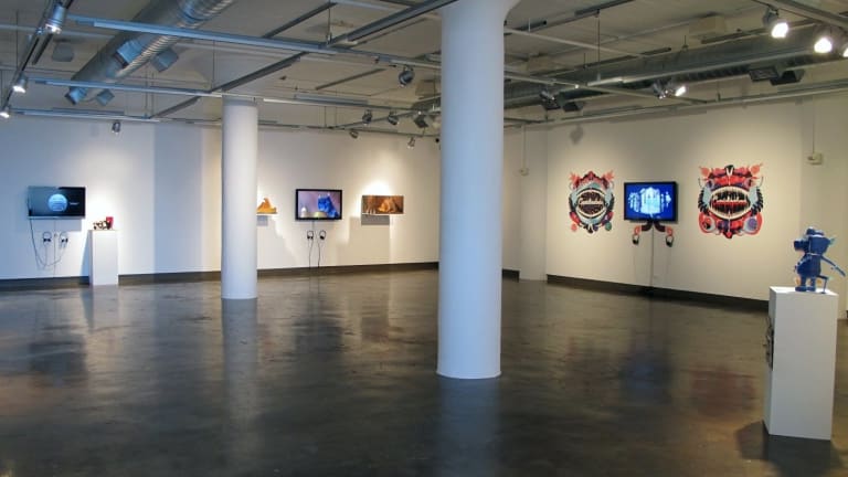room in a gallery with screens and contemporary art