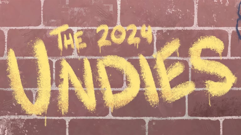 A brick wall with the words "The 2024 Undies" spray painted in yellow like grafitti