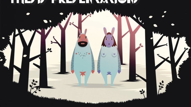 A man and woman in bunny style outfits standing in middle of dark forest