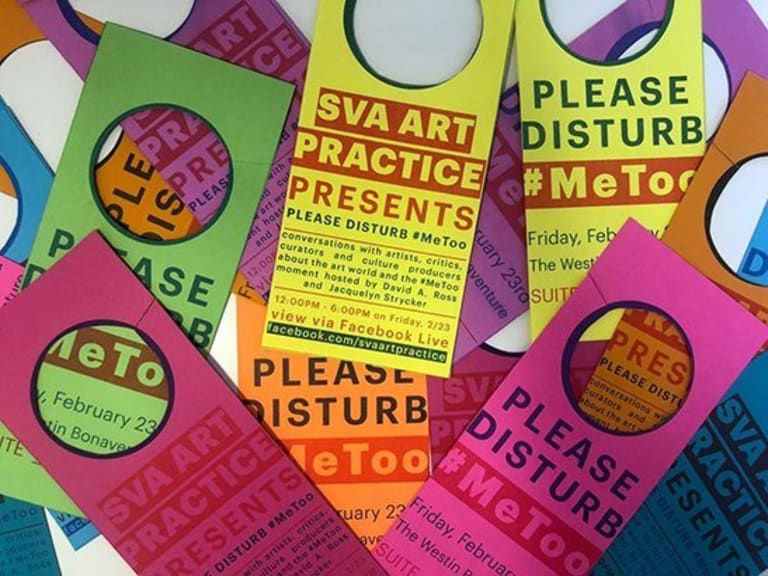 Various colored door signs on a table.