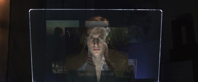 A man peers into a video screen.