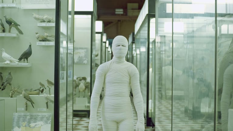 An image of a person wrapped up in gauze to resemble a mummy.