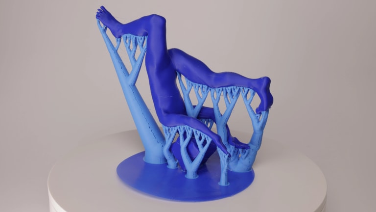 3D-printed in blue plastic human form flipping upside down on top of the 3D-printed support.