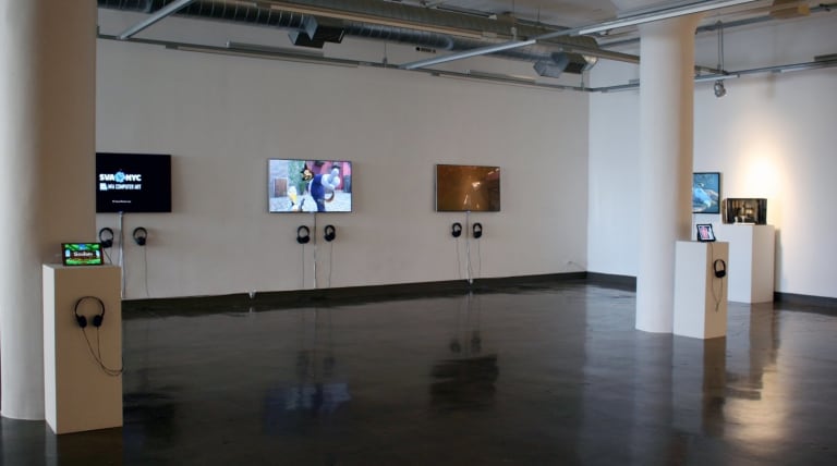 The empty room has three television screens. It also has two smaller tablets with head gear.
