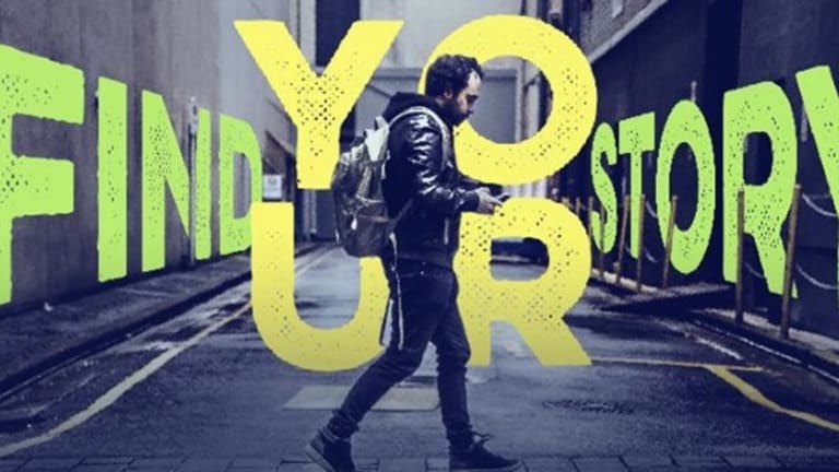 an ad "find your story" in yellow and green big letters with a walking man in the middle of the street