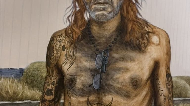 An elderly man with dog tags has tattoos all over him.