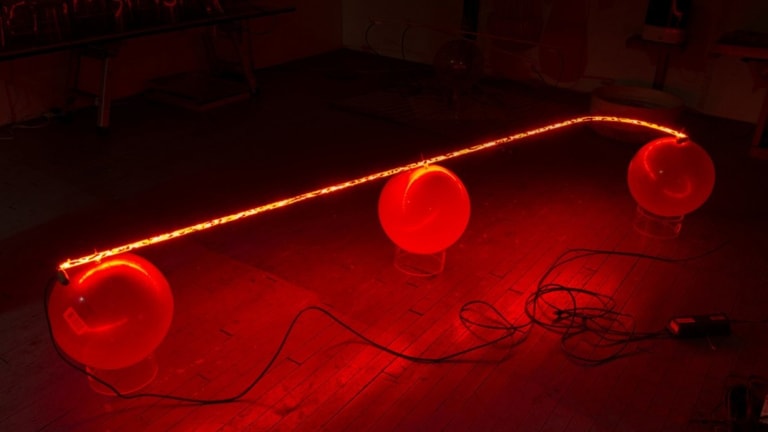 Three connected lighted red ornament balls