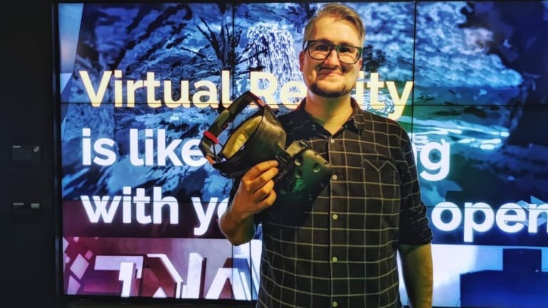 Image of a man holding a VR headset