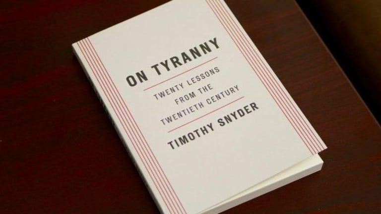 A white book with red stripes. The book is written by Timothy Snyder.