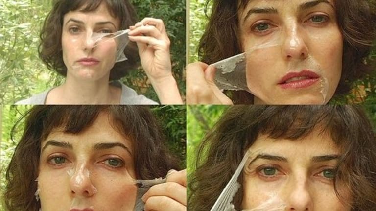 Woman demonstrating how to remove a peel off facial mask in four steps.