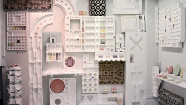 A set of mostly white objects that have spaces to hold objects. Most of the spaces are unoccupied.
