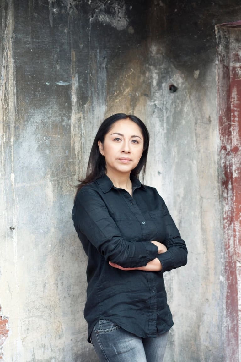 Picture of Minerva Cuevas standing against cement wall