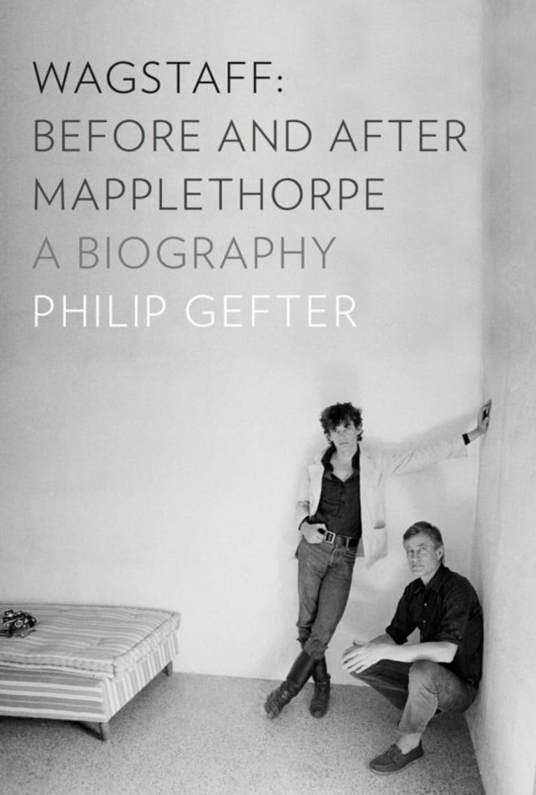 Two men posing in a room for a black and white photograph