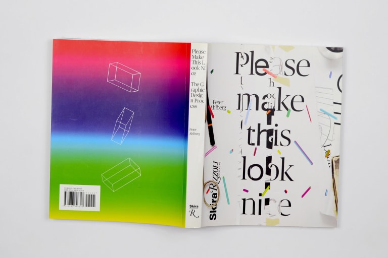 Book cover laid flat, rainbow colors on one side and type on the other.