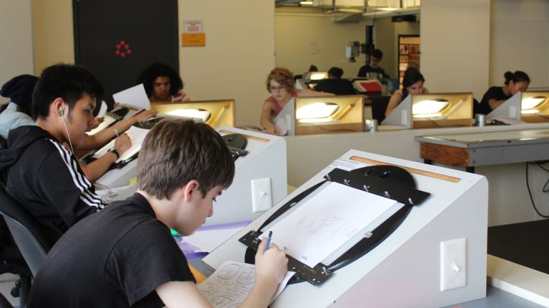 Students work on Animation cell drawings on light-tables