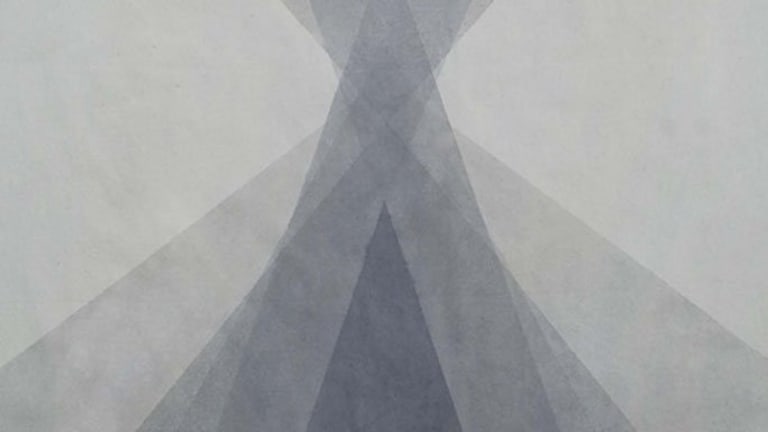 Different shades of gray in varying triangle sizes overlapping each other.