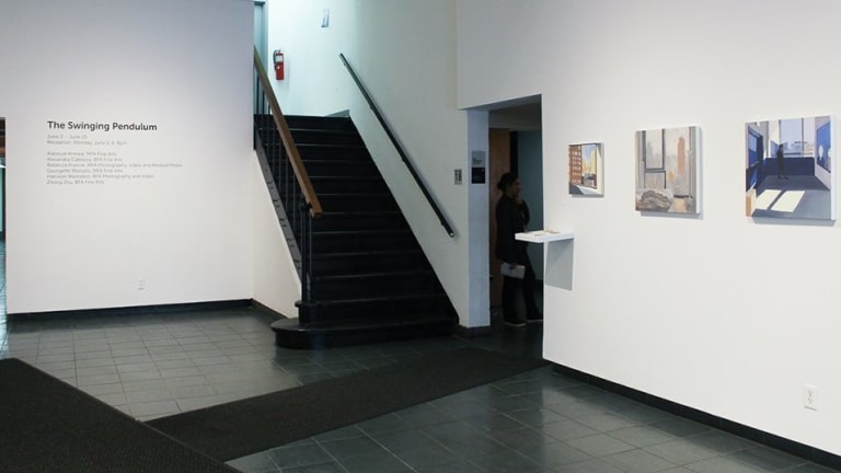 Art gallery with stairs in leading to the second floor.
