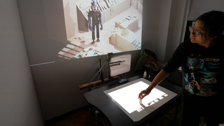 Person interacts with video game using a toy on a projected surface