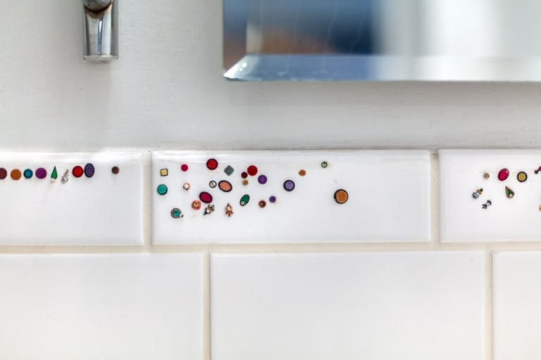 white tiles with colorful beads interspersed 