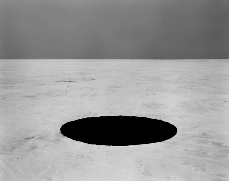 A black oval on a white surface.