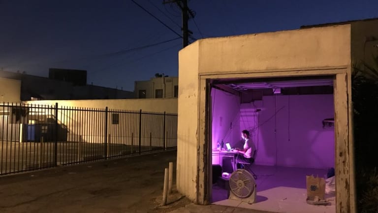 Luis Ortega Govela working in a garage. Photo by Nic Seago.