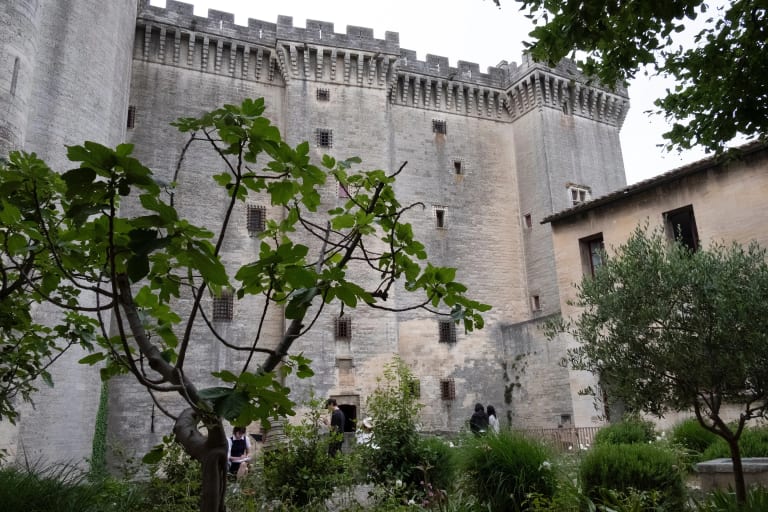 people sketch in garden outside castle