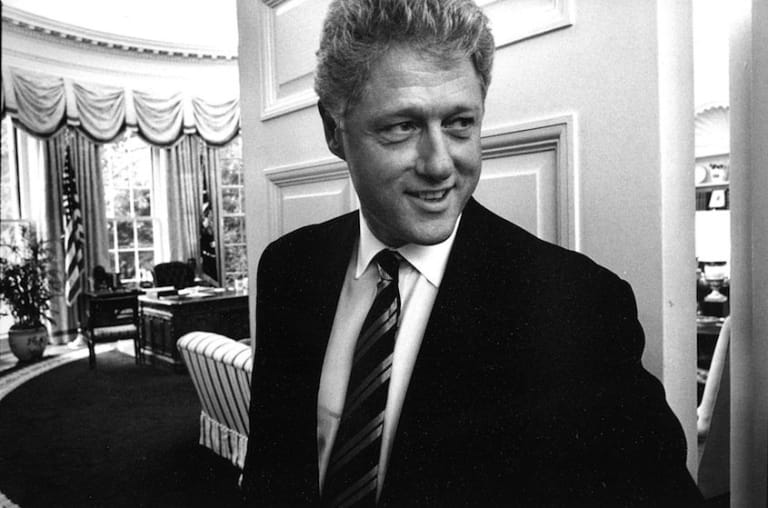 President Bill Clinton smiles as at the entryway of the oval office.