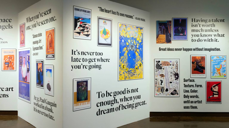 Posters of varying sizes intermixed with pull quotes in vinyl lettering across two walls.