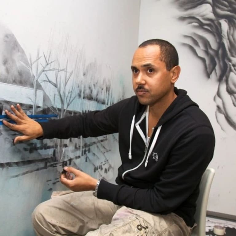 Image of Edgar Arceneaux working on black and drawing on the wall