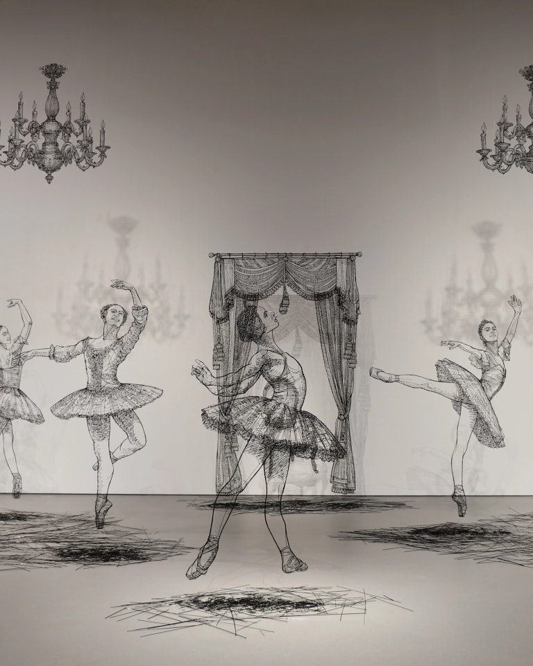 Sculptures made in black wire of several large scale ballerinas dancing around a white room.