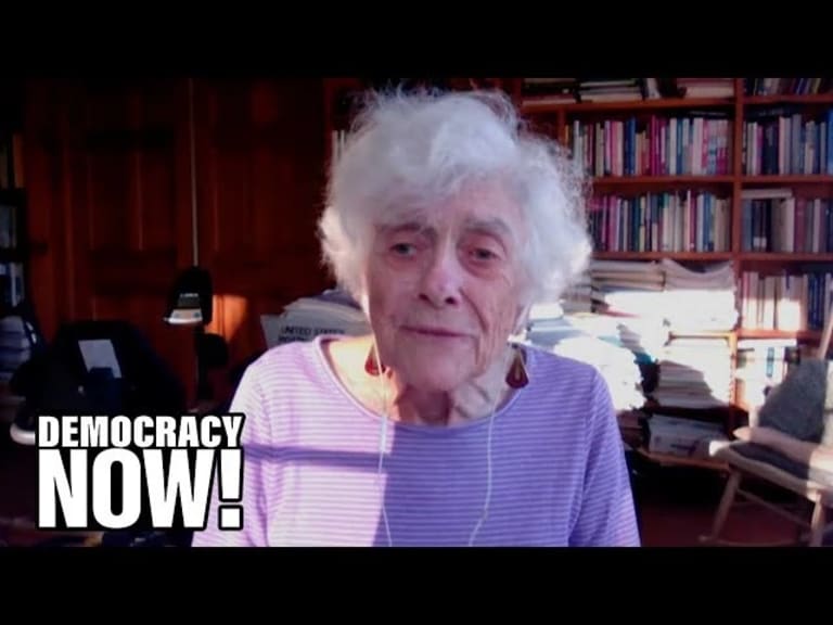 Frances Fox Piven in front of bookshelf, with Democracy Now logo