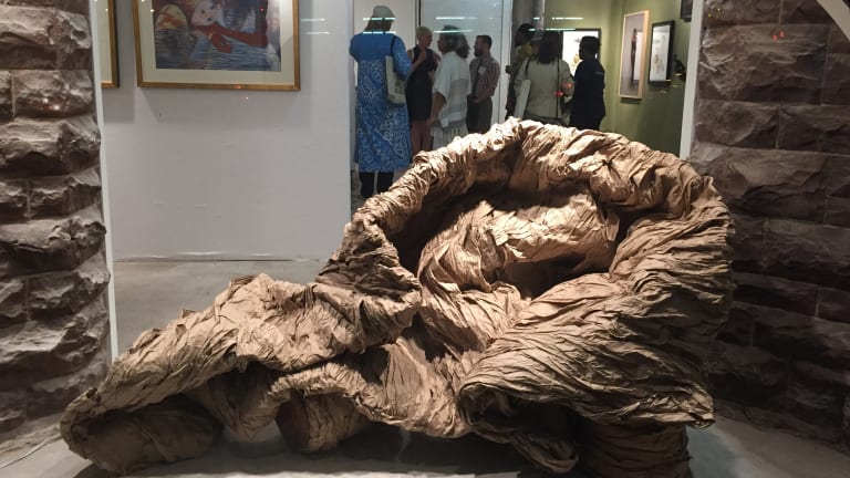 Here is a gallery featuring a sculpture by Dianne Smith that appears to be a twisted mass of igneous material.