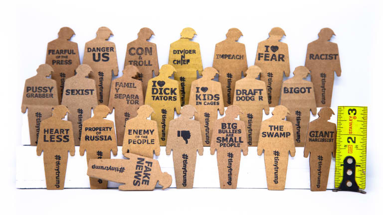 Here are cardboard silhouettes of President Trump, each bearing an epitaph describing his notoriety. 