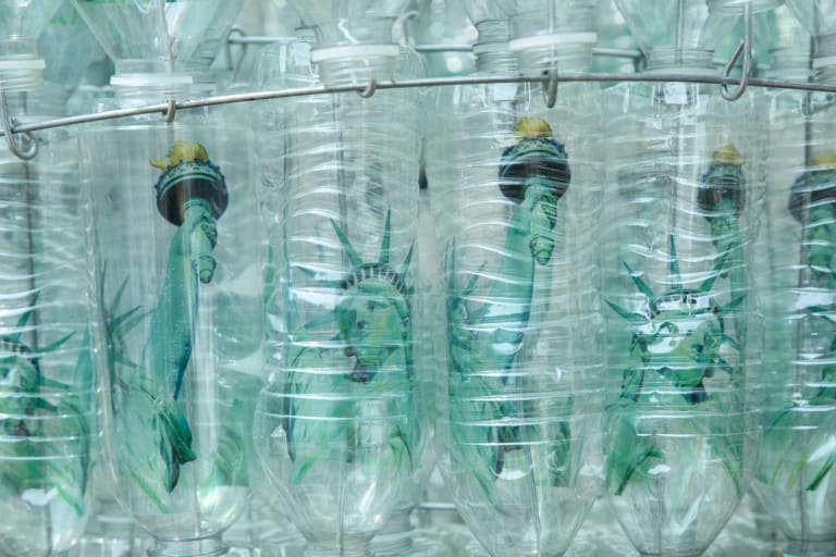 Image of water bottles with the statue of liberty printed on them, detail from a larger chandelier sculpture on Park Avenue.