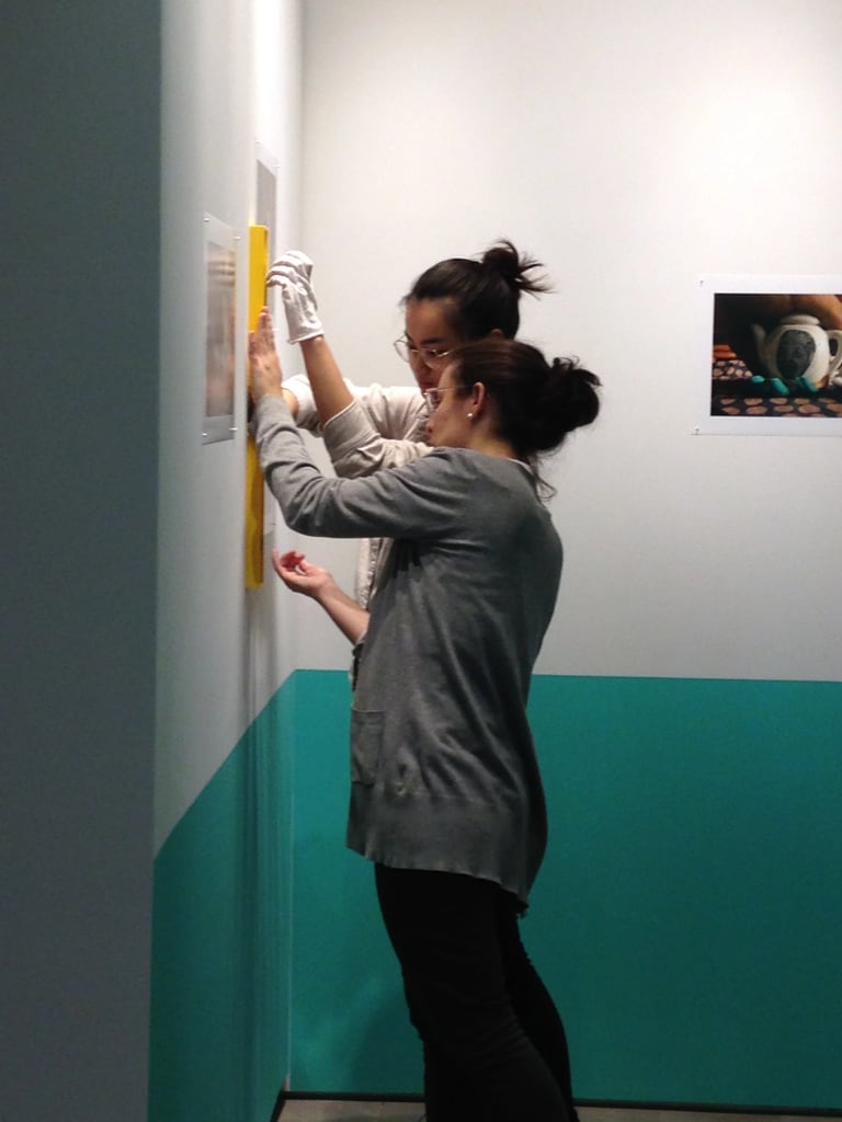 Two students installing an artwork 